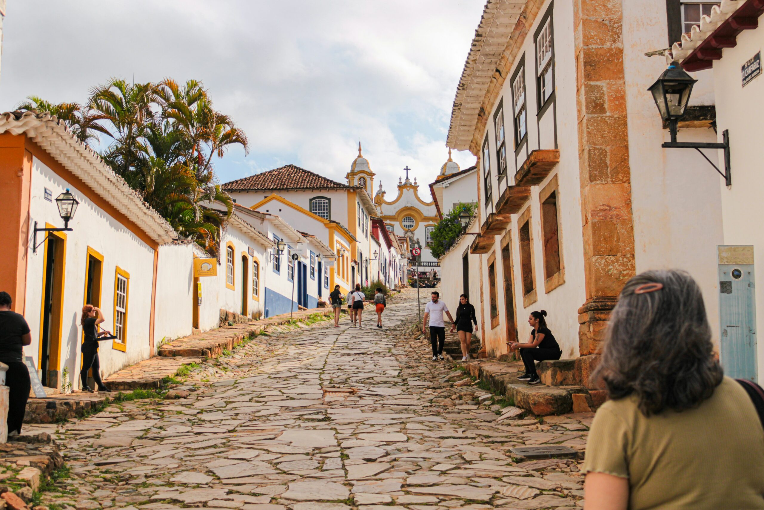 traveler walking through a historic European stone village during an ancestry and heritage travel experience.