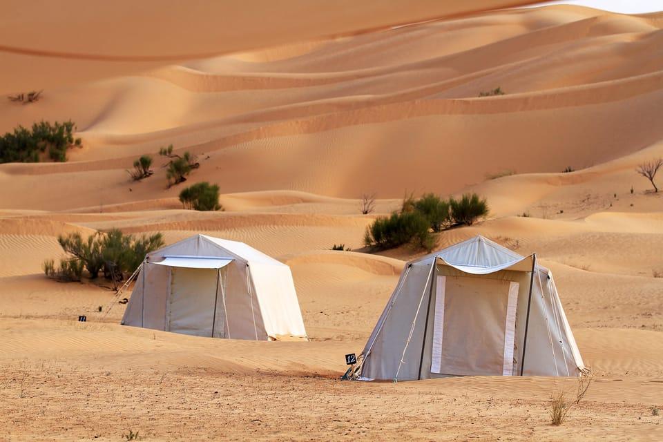Luxury desert camp setup under a starry night sky, preparing for the 2027 total solar eclipse.